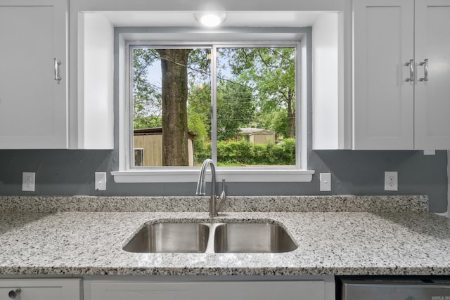 9317 Cynthia Dr, Little Rock, AR 72204 - kitchen featuring white cabinetry, light stone countertops, and dishwasher