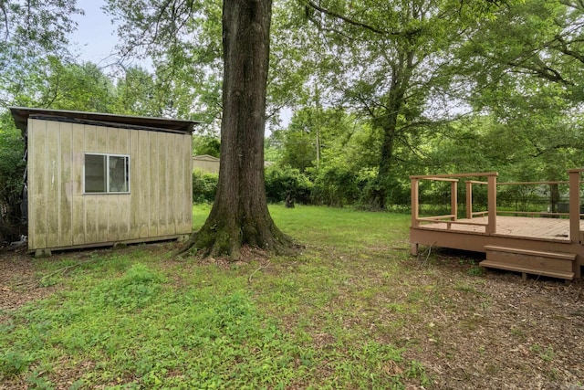 9317 Cynthia Dr, Little Rock, AR 72204 - view of grassy yard featuring a wooden deck and a storage shed