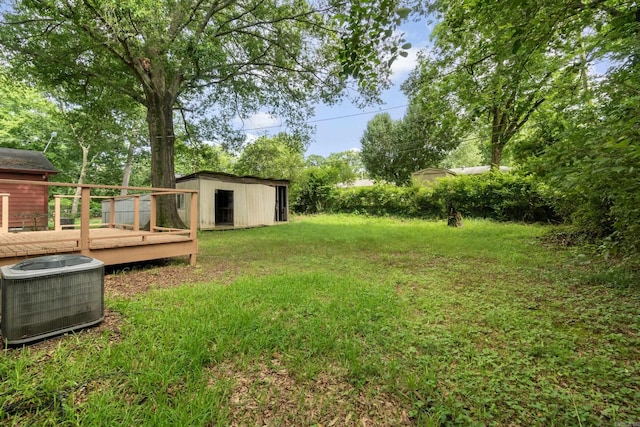 9317 Cynthia Dr, Little Rock, AR 72204 - view of green lawn with a wooden deck and an outdoor structure