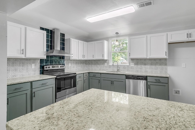 1550 E Main St, Austin, AR 72007 - kitchen featuring stainless steel appliances, wall chimney range hood, backsplash, and light stone counters