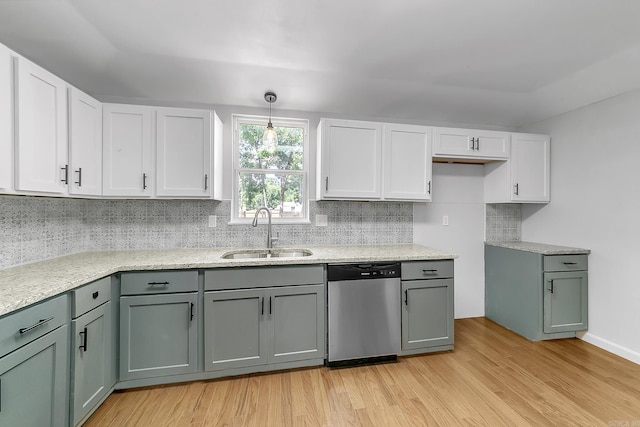 1550 E Main St, Austin, AR 72007 - kitchen featuring stainless steel dishwasher, light wood finished floors, tasteful backsplash, white cabinets, and hanging light fixtures