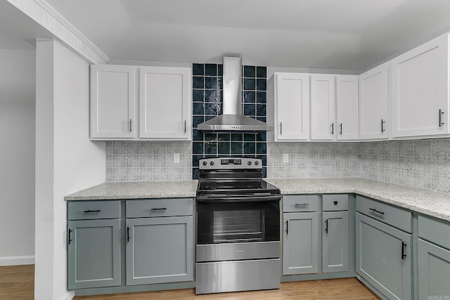 1550 E Main St, Austin, AR 72007 - kitchen featuring stainless steel range with electric stovetop, wall chimney exhaust hood, gray cabinetry, light wood-style flooring, and light stone countertops