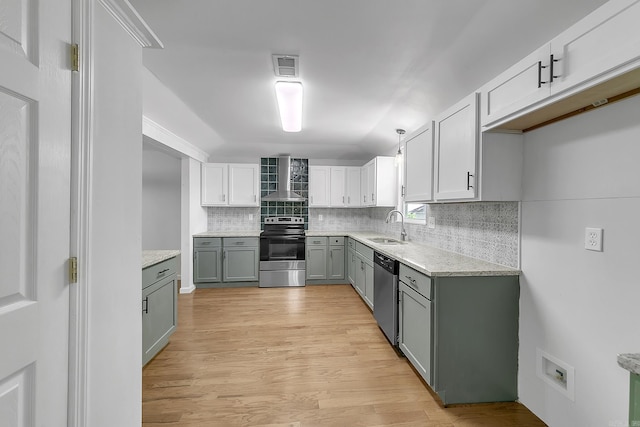 1550 E Main St, Austin, AR 72007 - kitchen with appliances with stainless steel finishes, wall chimney exhaust hood, backsplash, light wood-style flooring, and white cabinets