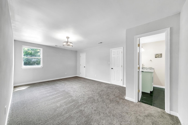 1550 E Main St, Austin, AR 72007 - empty room with dark colored carpet and baseboards