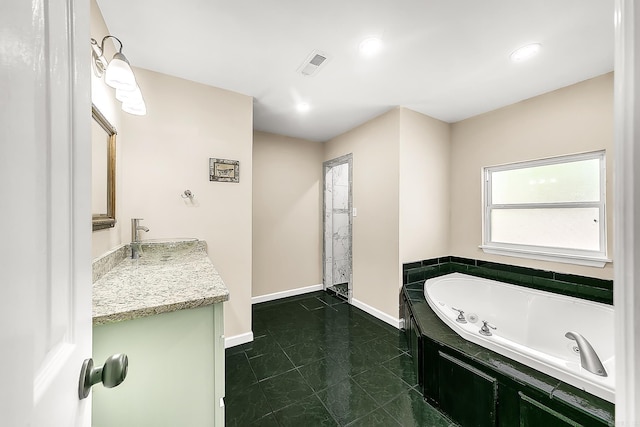 1550 E Main St, Austin, AR 72007 - full bath with vanity, a tub with jets, and tile patterned floors