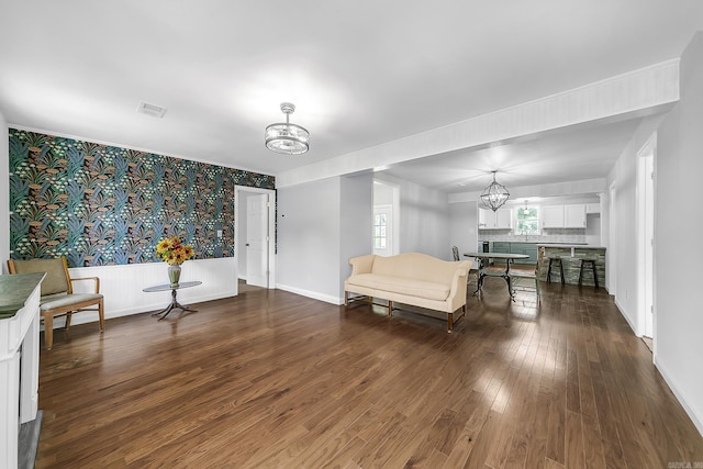 1550 E Main St, Austin, AR 72007 - living room with a chandelier, dark wood-type flooring, and wallpapered walls