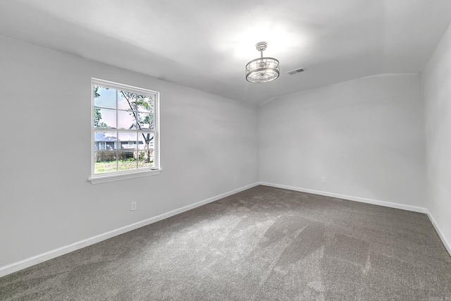 1550 E Main St, Austin, AR 72007 - empty room with dark colored carpet, a chandelier, and vaulted ceiling