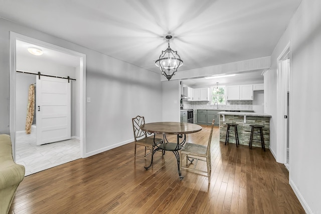 1550 E Main St, Austin, AR 72007 - dining space featuring a barn door, hardwood / wood-style flooring, and a chandelier
