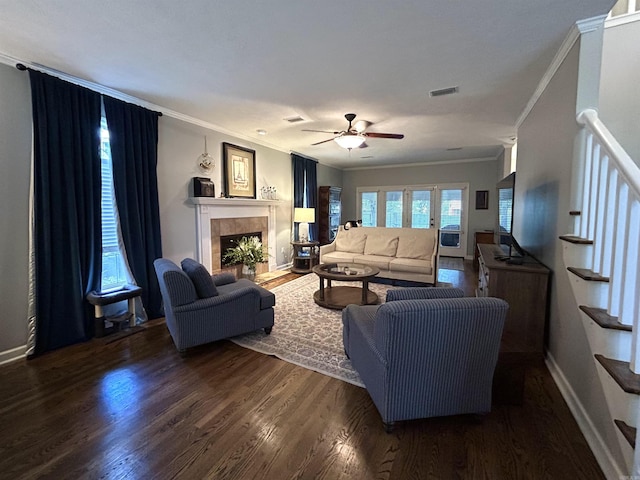 1715 Royal Dr, Conway, AR 72034 - living room with ornamental molding, dark wood-type flooring, a ceiling fan, stairs, and a tiled fireplace