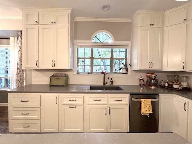 1715 Royal Dr, Conway, AR 72034 - kitchen featuring stainless steel dishwasher, backsplash, dark countertops, white cabinetry, and crown molding