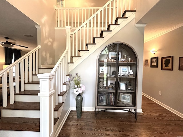 1715 Royal Dr, Conway, AR 72034 - stairway featuring a ceiling fan, ornamental molding, and wood finished floors