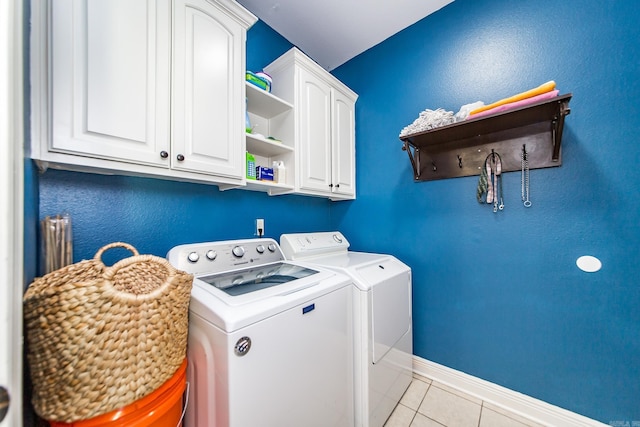 3200 Overcup Dr, Sherwood, AR 72120 - laundry area featuring washing machine and clothes dryer, cabinet space, and light tile patterned flooring