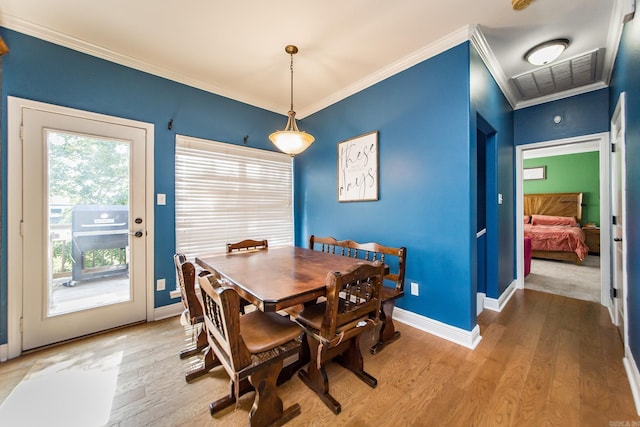3200 Overcup Dr, Sherwood, AR 72120 - dining area with ornamental molding and light wood-style flooring
