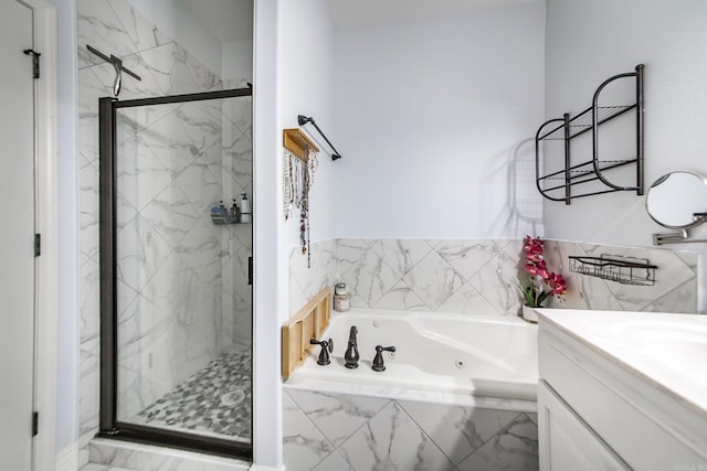 3200 Overcup Dr, Sherwood, AR 72120 - bathroom with a tub with jets, a marble finish shower, vanity, and marble look tiles