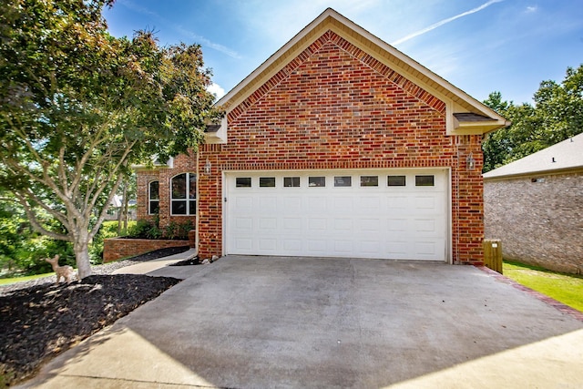3200 Overcup Dr, Sherwood, AR 72120 - view of front of house with brick siding, concrete driveway, and a garage