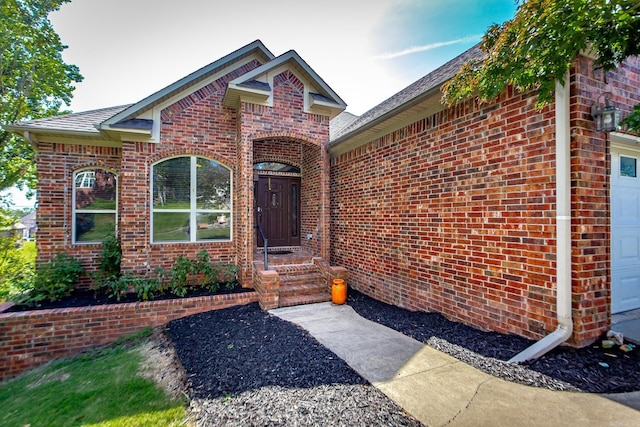 3200 Overcup Dr, Sherwood, AR 72120 - property entrance with brick siding, an attached garage, and a shingled roof