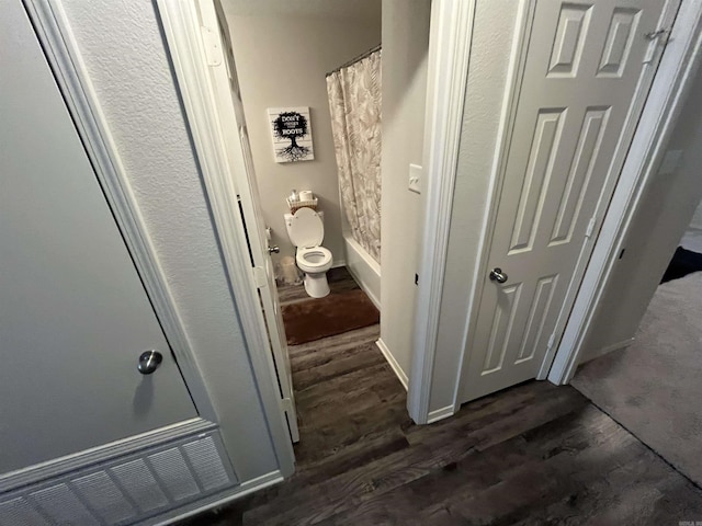 bathroom featuring wood finished floors and shower / bath combo