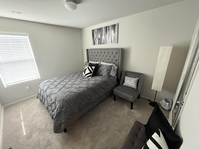 carpeted bedroom featuring baseboards
