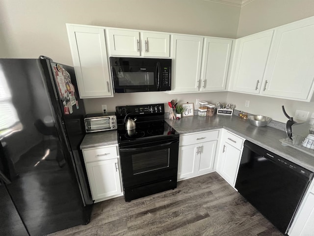kitchen featuring black appliances, dark wood-style flooring, and white cabinets