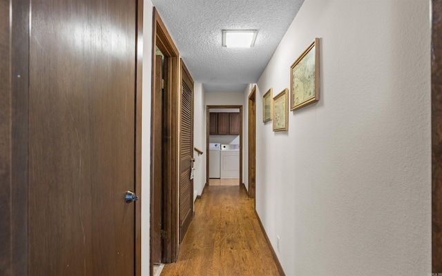 5 Torre Del Mar Way, Hot Springs Village, AR 71909 - corridor with washing machine and clothes dryer, a textured ceiling, wood finished floors, and a textured wall