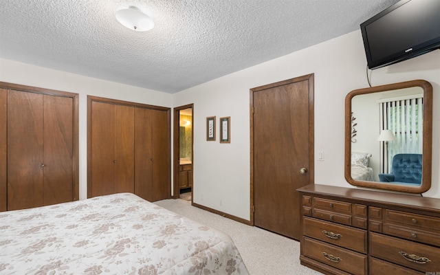 5 Torre Del Mar Way, Hot Springs Village, AR 71909 - bedroom with multiple closets, light carpet, a textured ceiling, and connected bathroom