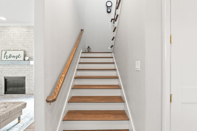 301 Kanis Ridge Dr, Little Rock, AR 72223 - stairway featuring a brick fireplace and recessed lighting