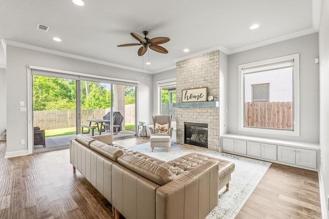 301 Kanis Ridge Dr, Little Rock, AR 72223 - living area with a ceiling fan, wood finished floors, crown molding, recessed lighting, and a brick fireplace