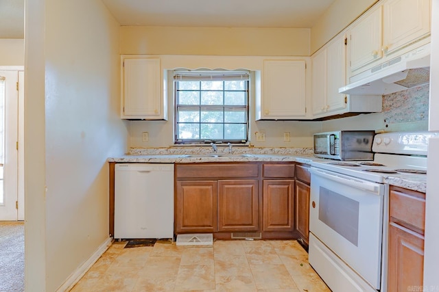 1304 Dupwe Dr, Jonesboro, AR 72401 - kitchen with white appliances, under cabinet range hood, light stone countertops, and white cabinetry