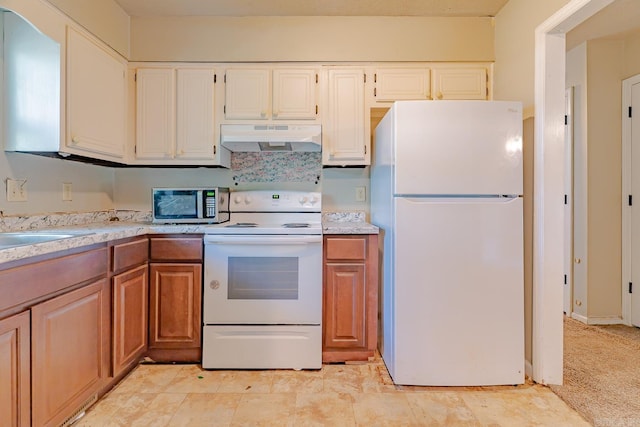 1304 Dupwe Dr, Jonesboro, AR 72401 - kitchen with white appliances, under cabinet range hood, light countertops, and white cabinetry
