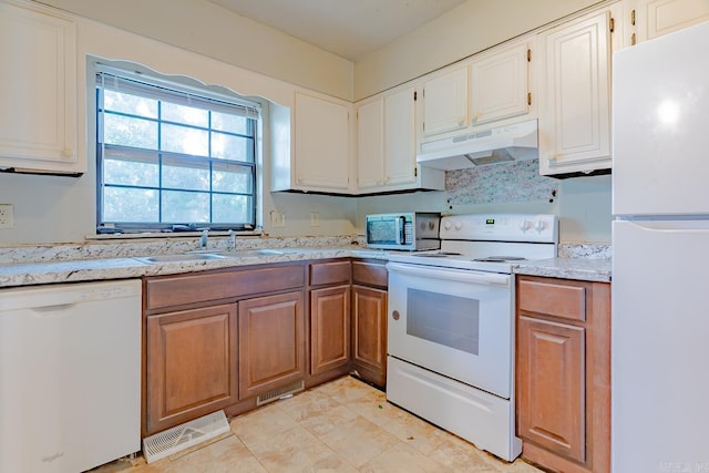 1304 Dupwe Dr, Jonesboro, AR 72401 - kitchen featuring white appliances, under cabinet range hood, brown cabinets, and white cabinetry