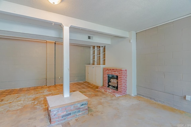 1304 Dupwe Dr, Jonesboro, AR 72401 - finished below grade area featuring concrete block wall, a textured ceiling, and a wood stove