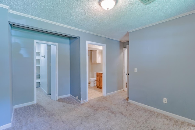 1304 Dupwe Dr, Jonesboro, AR 72401 - unfurnished bedroom featuring crown molding, a textured ceiling, carpet flooring, a spacious closet, and connected bathroom