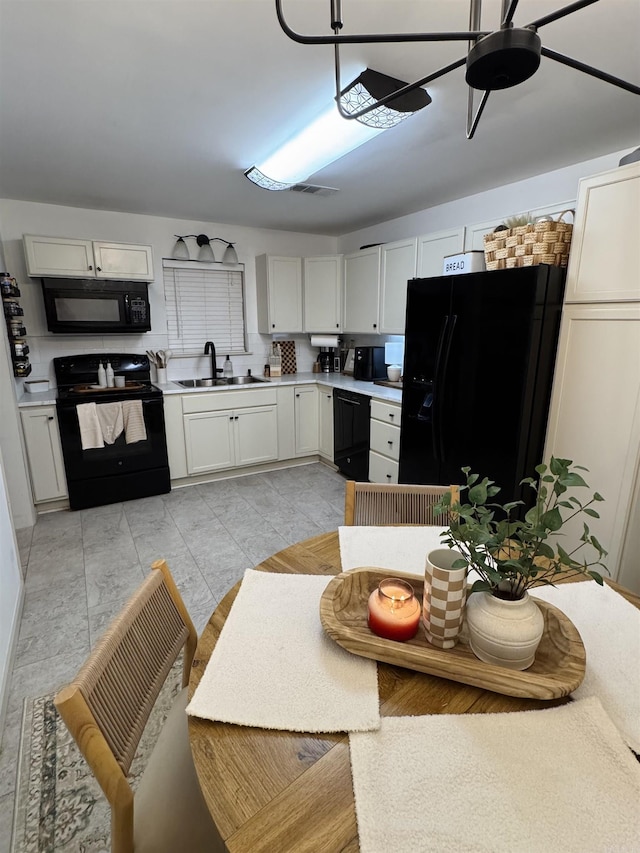 117 S Briarwood, Sheridan, AR 72150 - kitchen with black appliances, light countertops, a ceiling fan, and white cabinetry