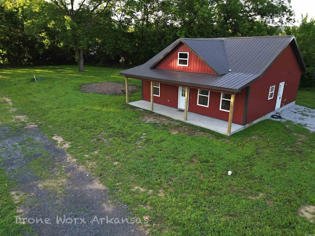 405 Walnut St, Marshall, AR 72650 - view of front of home with a front lawn, a metal roof, covered porch, and view of scattered trees