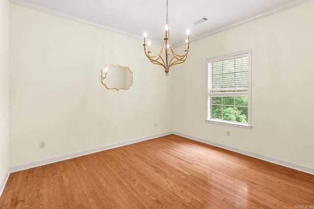 2219 Westport Loop, Little Rock, AR 72212 - empty room featuring a chandelier, crown molding, and light wood-style floors