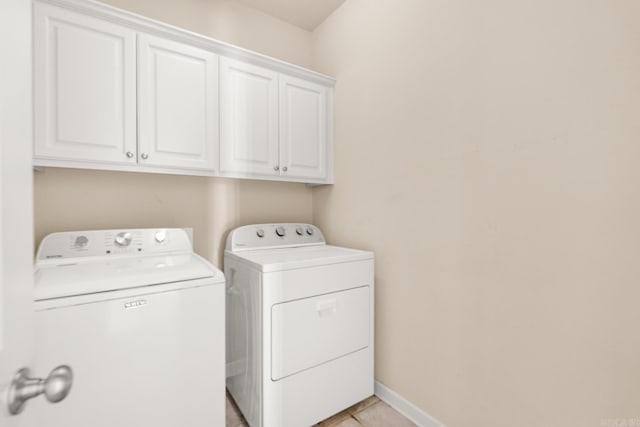 2219 Westport Loop, Little Rock, AR 72212 - laundry room with washer and clothes dryer, cabinet space, and light tile patterned floors
