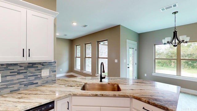 56 Blair, Vilonia, AR 72173 - kitchen featuring backsplash, a chandelier, light stone counters, decorative light fixtures, and white cabinetry