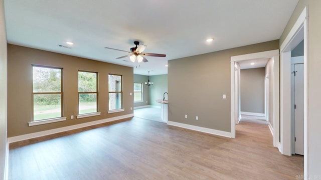 56 Blair, Vilonia, AR 72173 - unfurnished living room with plenty of natural light, ceiling fan, light wood-style floors, and recessed lighting