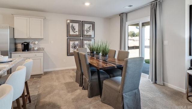 dining room with light colored carpet
