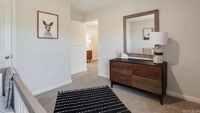 bedroom with carpet floors and baseboards