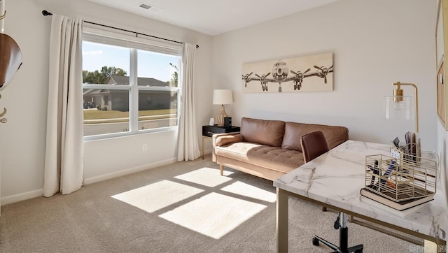 carpeted living area with baseboards