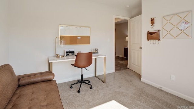 carpeted home office with baseboards