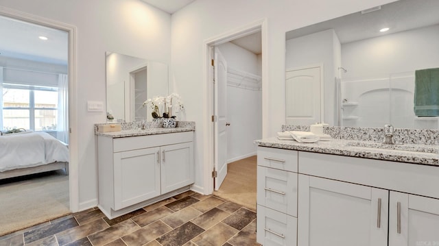 3416 Hank Dr, Jonesboro, AR 72404 - bathroom featuring two vanities and a walk in closet