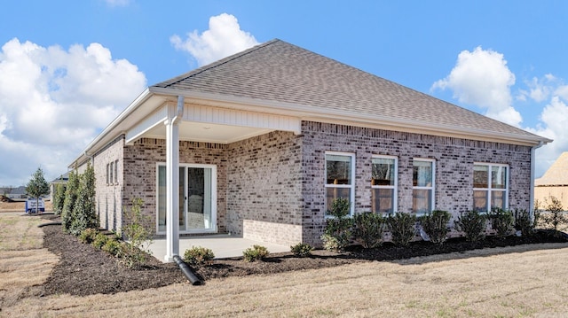 3416 Hank Dr, Jonesboro, AR 72404 - view of side of property with brick siding, a patio area, and a shingled roof