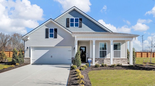 3416 Hank Dr, Jonesboro, AR 72404 - view of front facade featuring covered porch, a garage, and concrete driveway