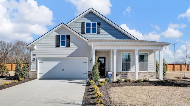 3416 Hank Dr, Jonesboro, AR 72404 - view of front of property with a porch, a garage, driveway, and brick siding
