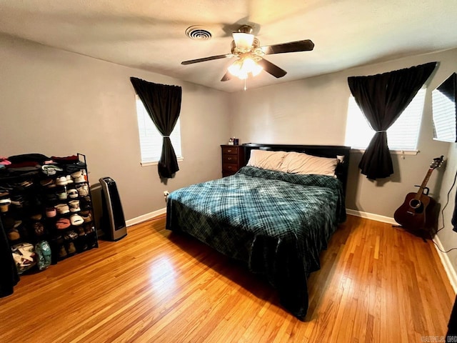 6312 Sandy Ln, Little Rock, AR 72204 - bedroom with light wood-style floors, multiple windows, and ceiling fan