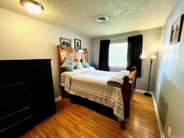 6312 Sandy Ln, Little Rock, AR 72204 - bedroom featuring a textured ceiling and wood finished floors