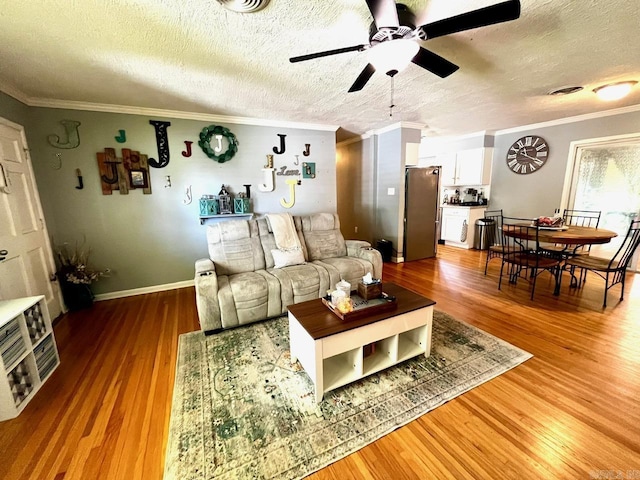 6312 Sandy Ln, Little Rock, AR 72204 - living area featuring ceiling fan, crown molding, wood finished floors, and a textured ceiling