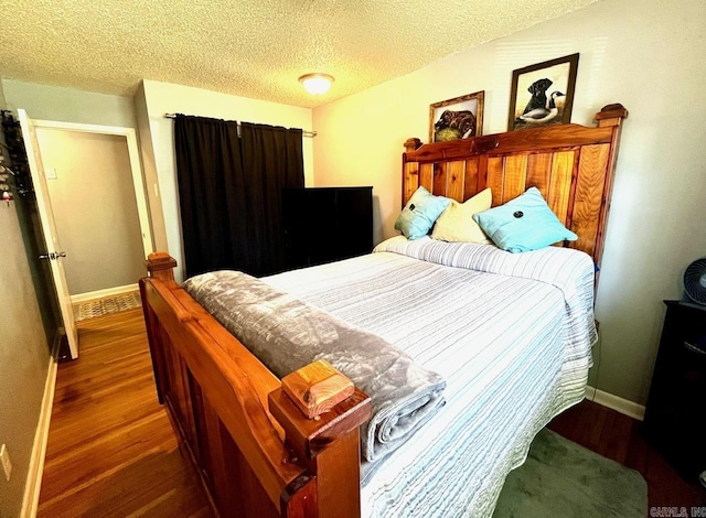 6312 Sandy Ln, Little Rock, AR 72204 - bedroom with wood finished floors and a textured ceiling